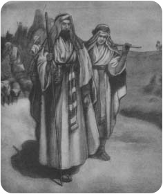 Two robed travellers walking with a group behind them