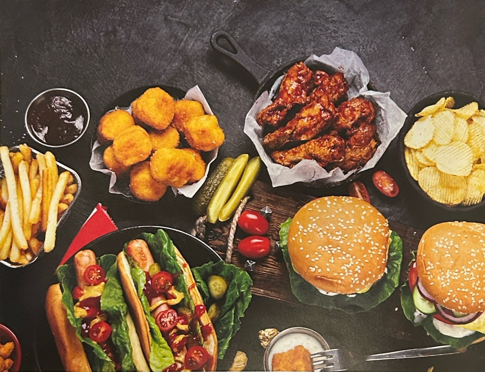 Hamburgers, hot dogs, fries, nuggets, chicken wings and potato chips.