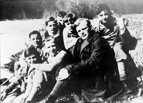 Dietrich Bonhoeffer seated with school children outdoors