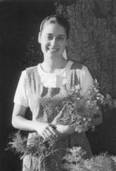 A young woman holding a bouquet of flowers.
