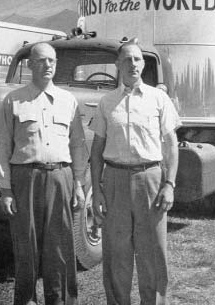Two men beside a revival vehicle
