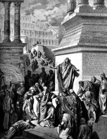 A robed man addresses a gathering beside large stone buildings.