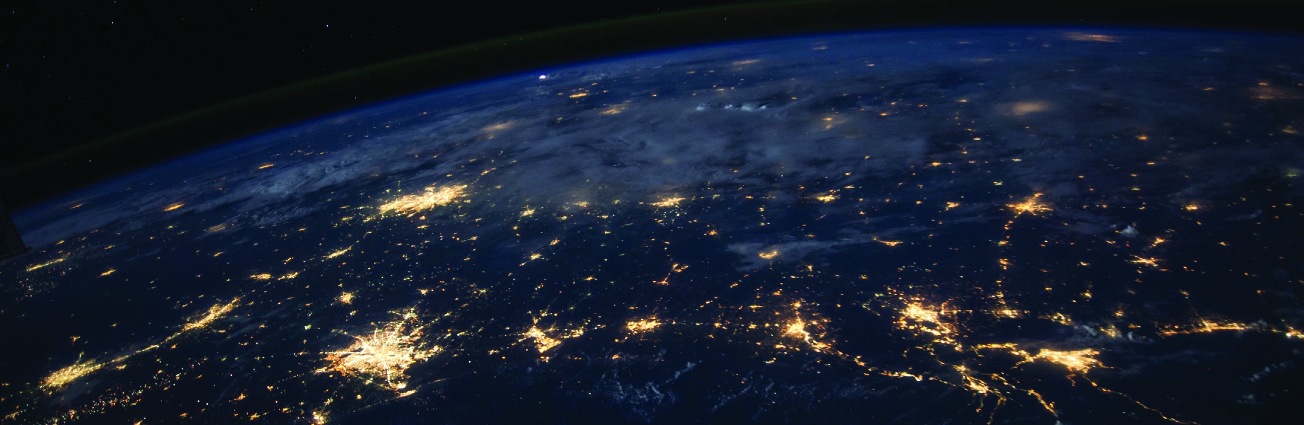 Earth at night seen from orbit with illuminated cities