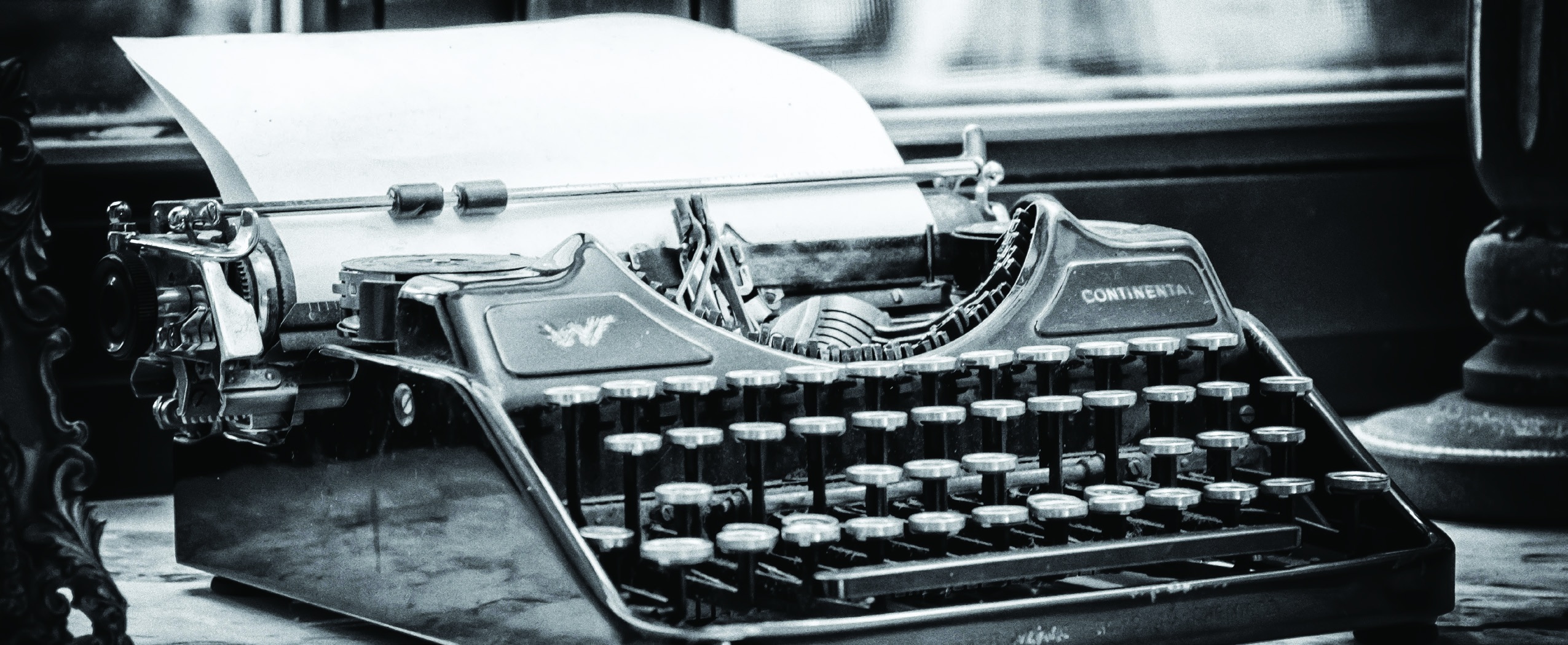 Vintage typewriter holding a blank sheet of paper