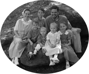 A family seated outdoors.