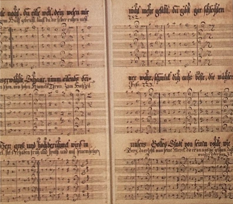 Two facing pages of a handwritten Cloister song book with musical notation.