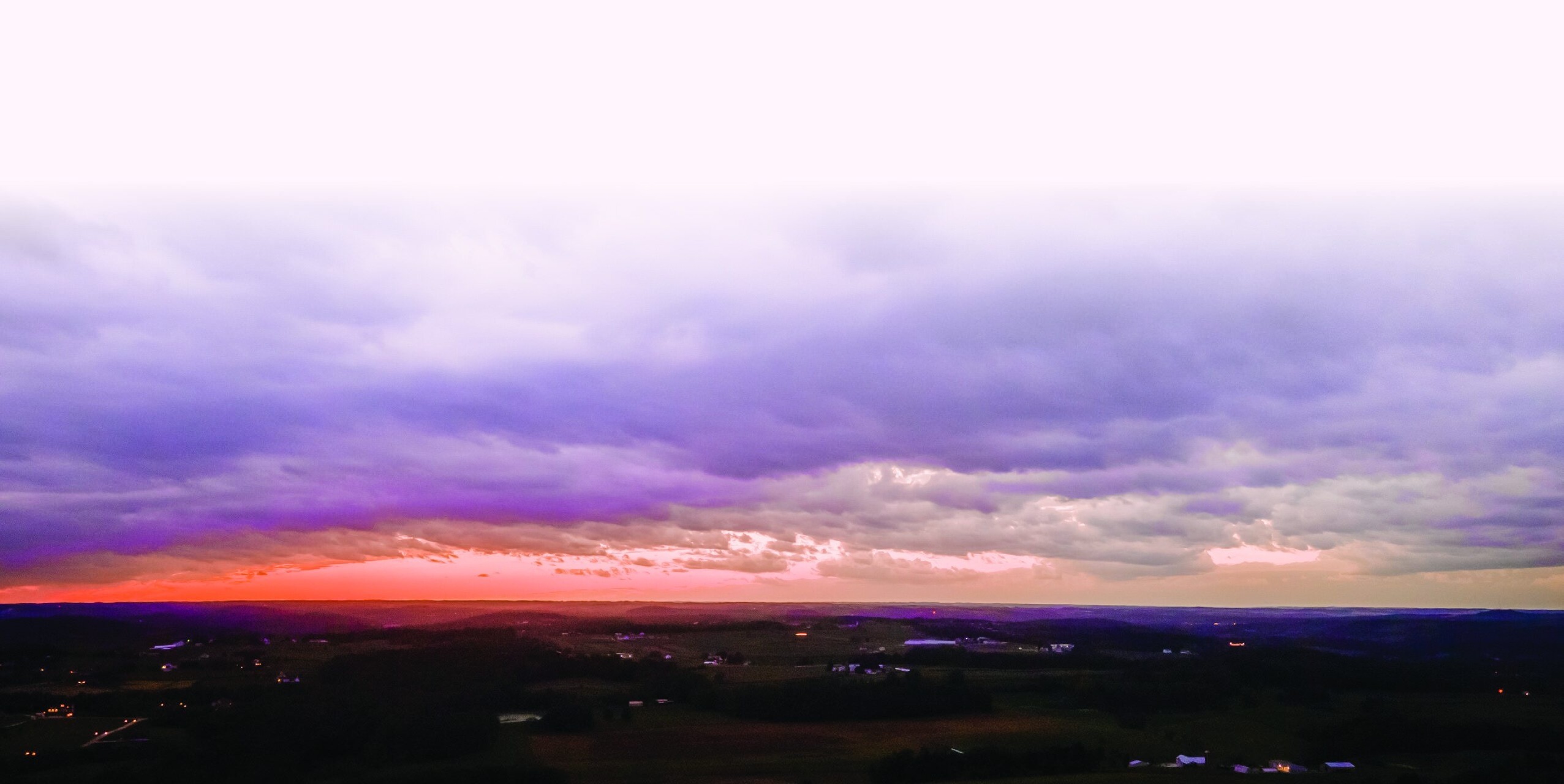 Panoramic storm clouds at sunset over countryside