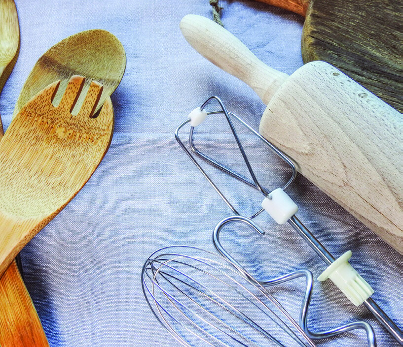 Wooden kitchen utensils, a rolling pin, and mixer attachments