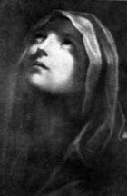 A woman with a head covering looking upward