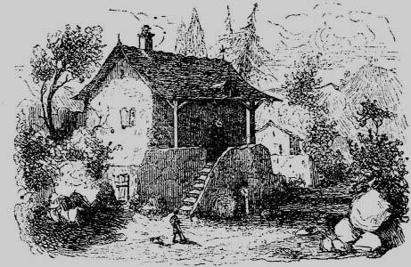 A cottage among trees with people outside
