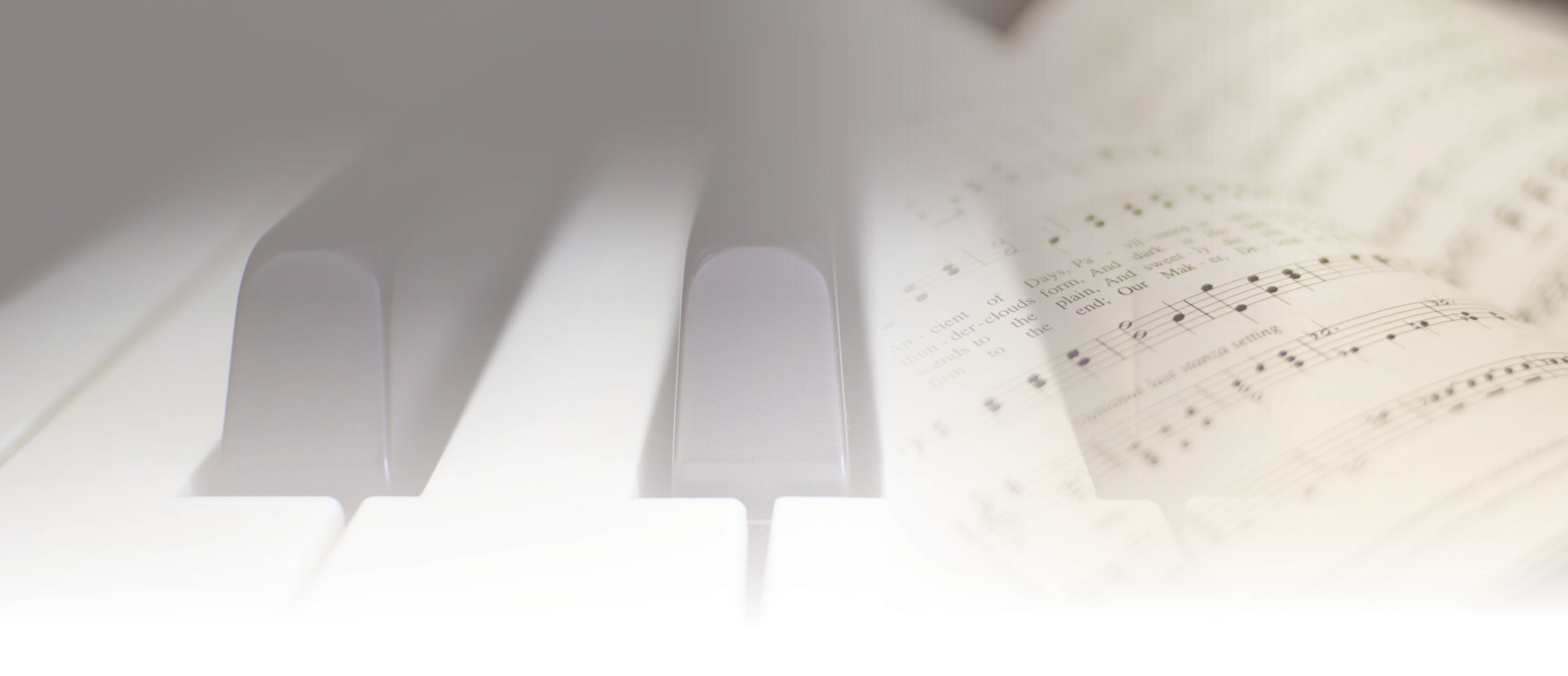 Piano keys beside open sheet music