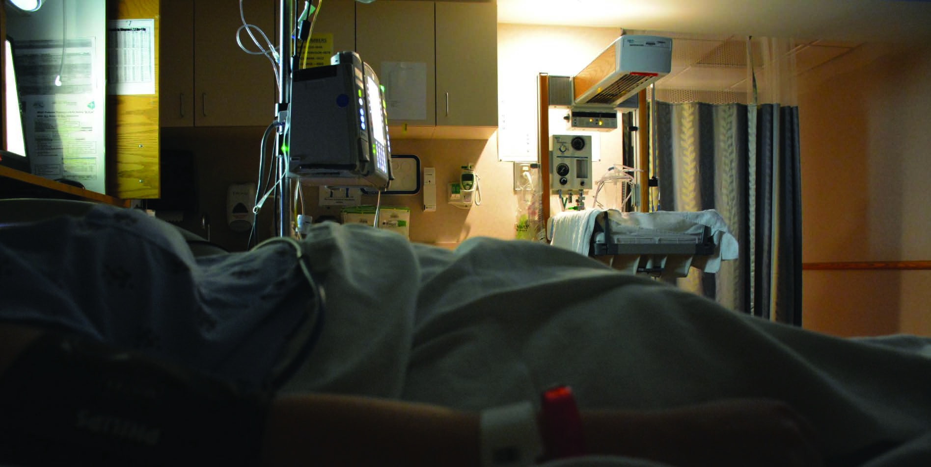 A hospital room viewed from a patient bed