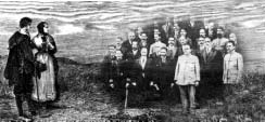 A group of adults and children standing outdoors
