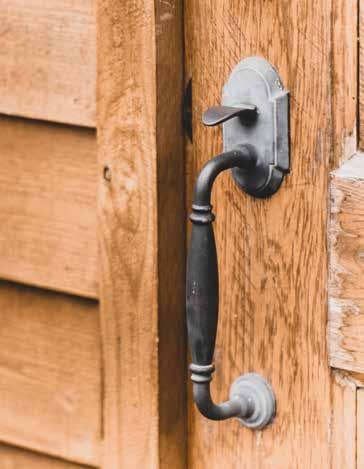 A dark metal latch on a wooden door