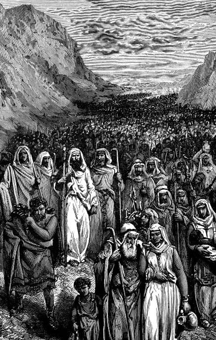 A crowd gathered in a valley between steep mountains
