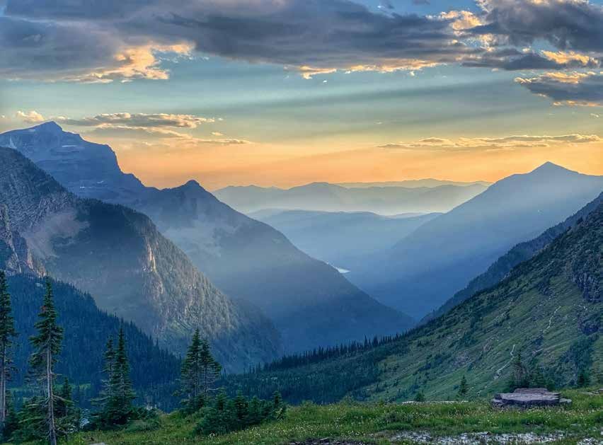 A mountain valley beneath a glowing sky