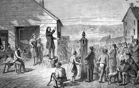A preacher addressing people outdoors