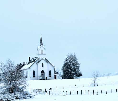 A white church in a snowy rural landscape
