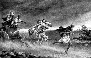 A man running ahead of a horse-drawn chariot.