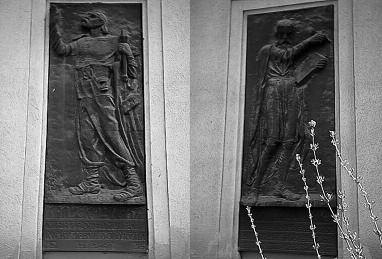 Two carved reliefs of armed men on a Czech monument.