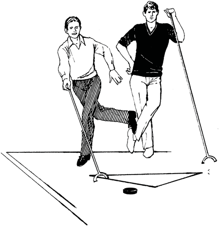 Two men playing shuffleboard