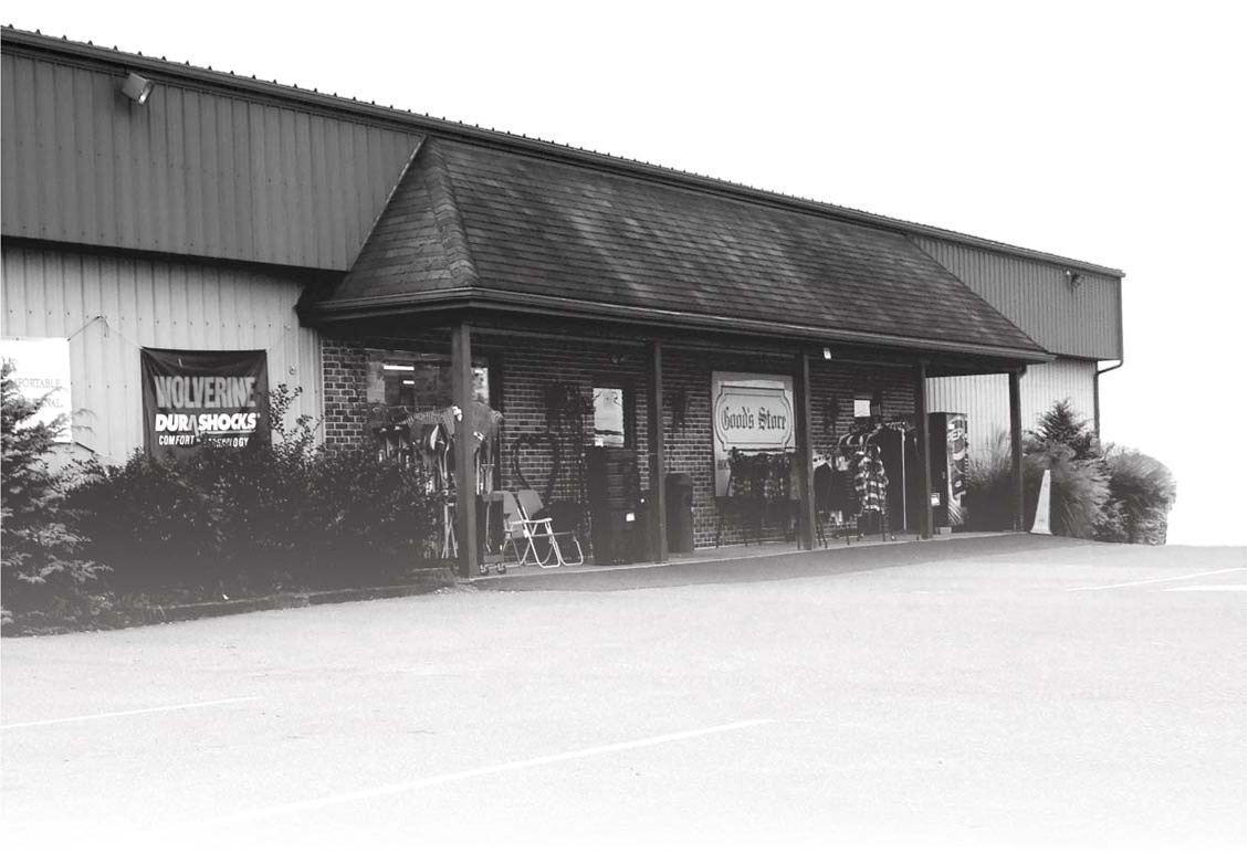 Good’s Store building, people and parking area