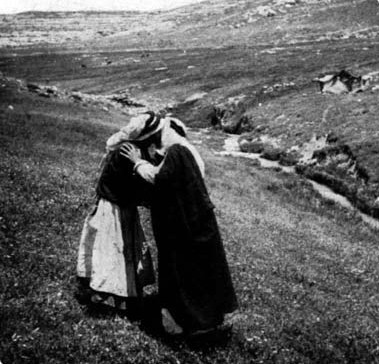 Two women greeting one another outdoors