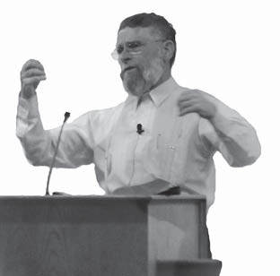 Bro. Denny preaching from behind a pulpit