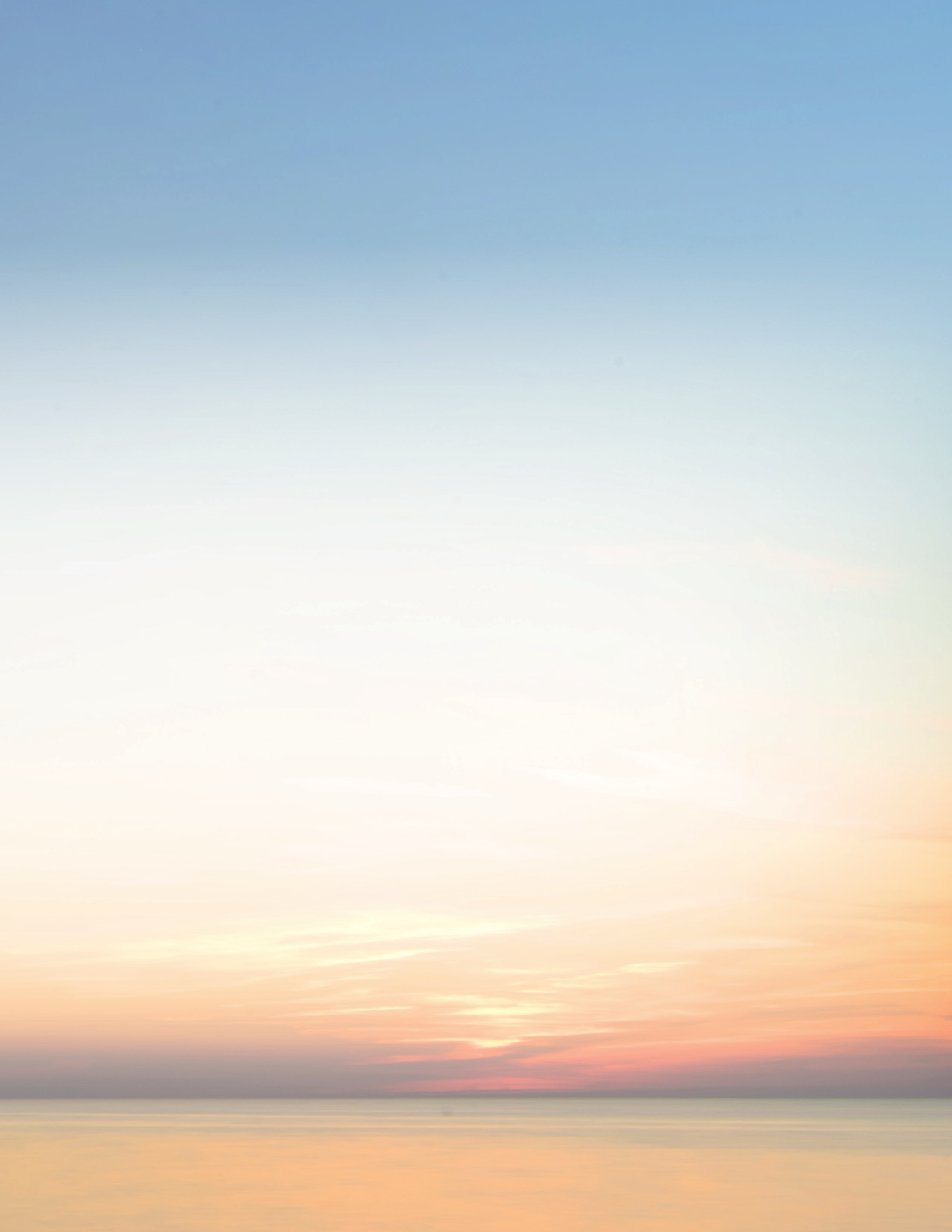 Sunrise over waves breaking along a rocky shore