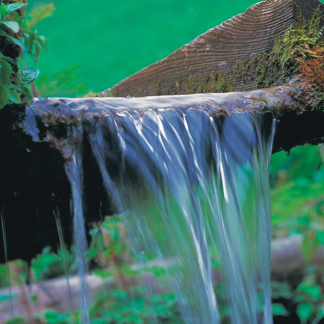 Water flowing over a wooden channel