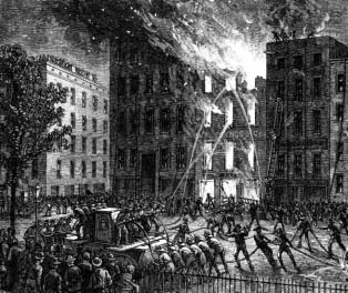 Firefighters directing water onto a burning building.