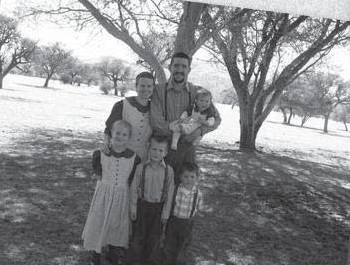 Van der Merwe family standing beneath a tree