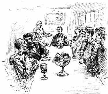 A group of people seated around a dinner table as a woman serves them