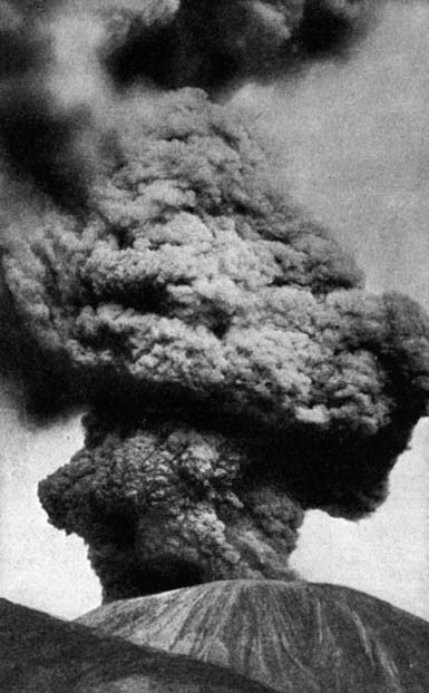 An erupting volcano with a tall ash cloud