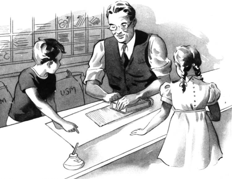 A man speaking with two children at a desk