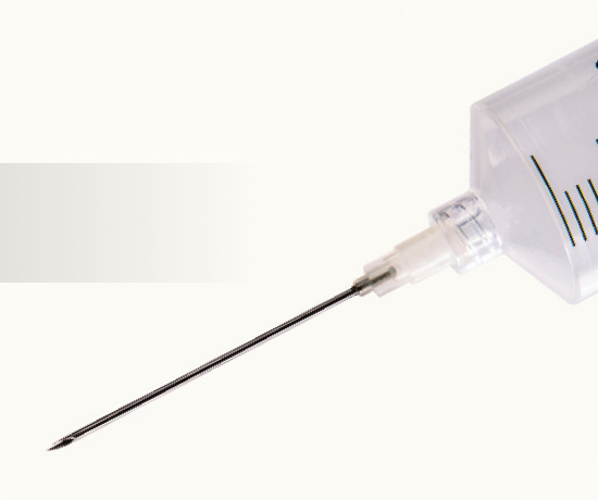 A syringe and needle prepared for an injection