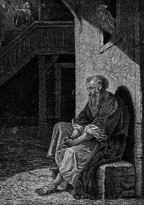 A seated man beneath a wooden staircase