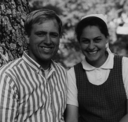 A smiling man and woman standing together outdoors.