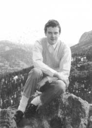 Daniel Kauffman sitting on rocks outdoors.
