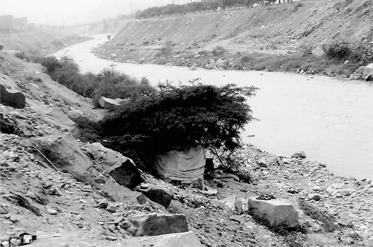 Improvised shelter beside the Rimac River in Lima
