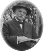 Portrait of Gregory Mantle holding an open book.