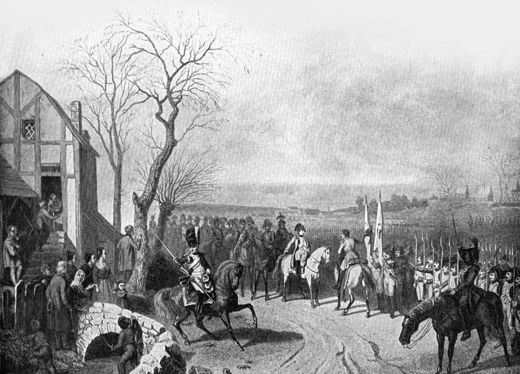 Mounted soldiers and troops passing a house