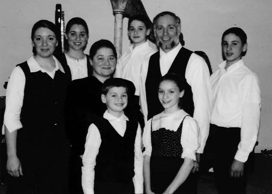Eight people posing for a family photograph