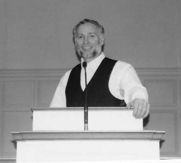 A man speaking at a lectern