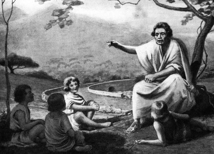 A seated man points toward a distant scene while children listen