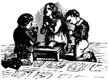 Three children kneel with clasped hands beside an open book