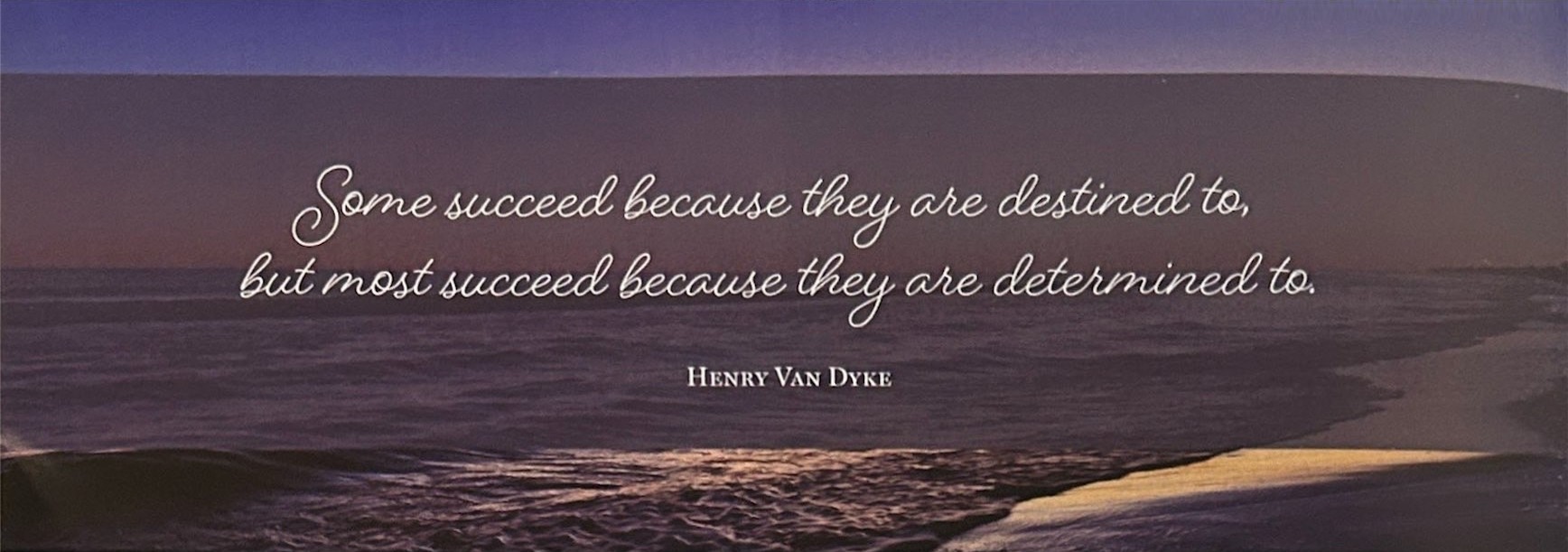 Waves meet a sandy shore at dusk beneath a quotation attributed to Henry Van Dyke.