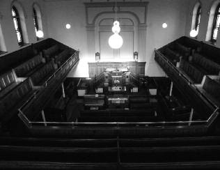 Photograph of a chapel interior seen from the upper gallery