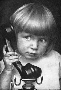 Child holding a telephone receiver