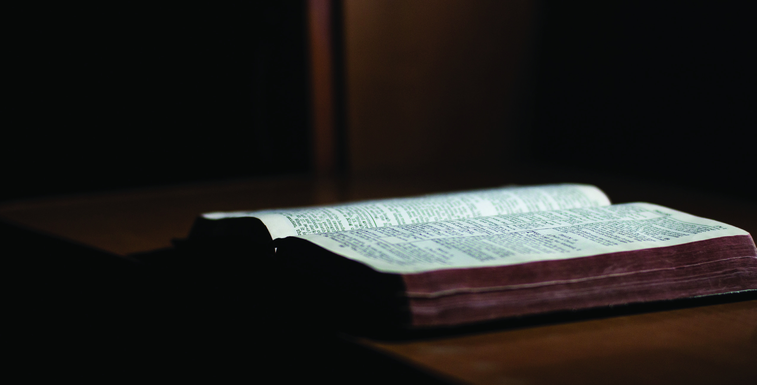 An open Bible resting on a table